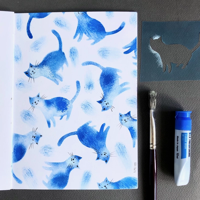 Stencilled blue cats pattern in sketchbook